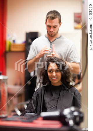 Portrait of a man combing hair 6403930