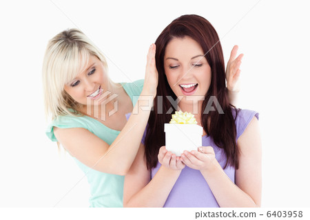 Gorgeous woman gifting her friend 6403958