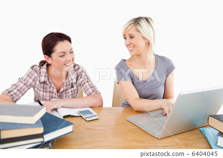 Lovely women learning with laptop and books Lovely women learning with laptop and books 6404045