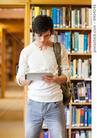 Portrait of a focused student using a tablet computer 6404048