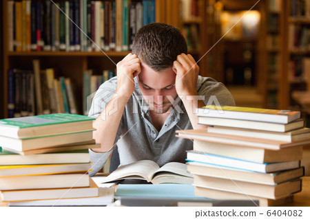 Tired student having a lot to read 6404082