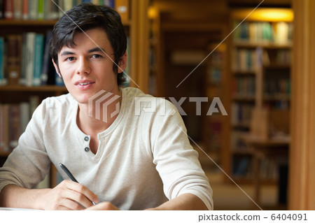 Student holding a pen 6404091