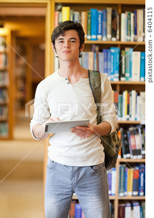 Portrait of a smiling student holding a tablet computer Portrait of a smiling student holding a tablet computer 6404115