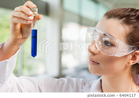 Female science student looking at a test tube Female science student looking at a test tube 6404117