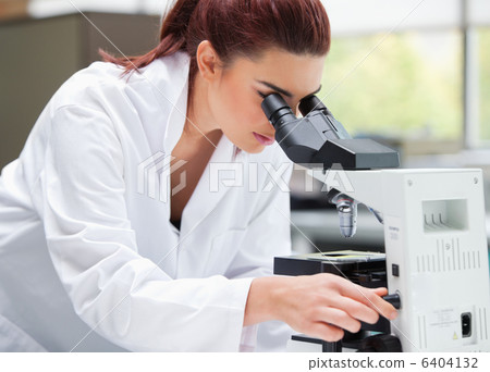 Young scientist looking into a microscope Young scientist looking into a microscope 6404132