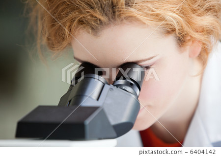 Close up of a young student looking into a microscope Close up of a young student looking into a microscope 6404142