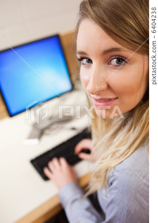 Young businesswoman using a computer Young businesswoman using a computer 6404238