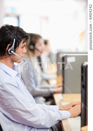 Portrait of young operators using a computer Portrait of young operators using a computer 6404242