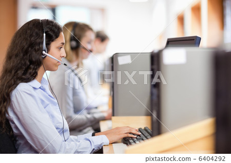 Customer assistant working with a computer 6404292
