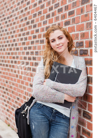 Portrait of a lovely student holding her binder Portrait of a lovely student holding her binder 6404467