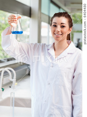Portrait of a science student holding an Erlemeyer flask Portrait of a science student holding an Erlemeyer flask 6404480