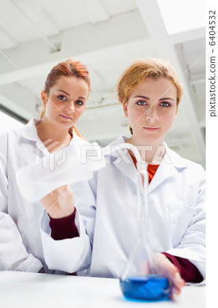 Portrait of cute science students doing an experiment Portrait of cute science students doing an experiment 6404532