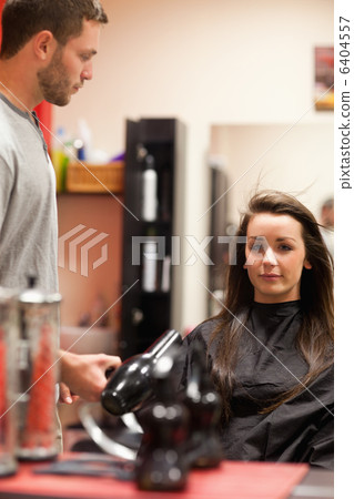 Portrait of a male hairdresser blowing hair 6404557
