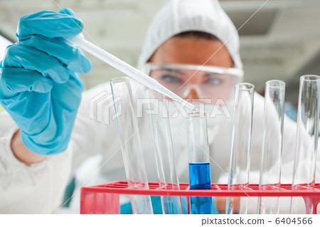 Close up of a protected scientist dropping liquid in a test tube Close up of a protected scientist dropping liquid in a test tube 6404566