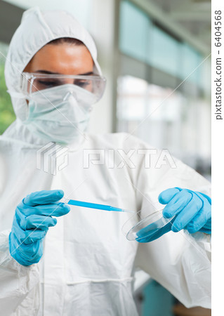 Portrait of a protected female science student dropping blue liq 6404568