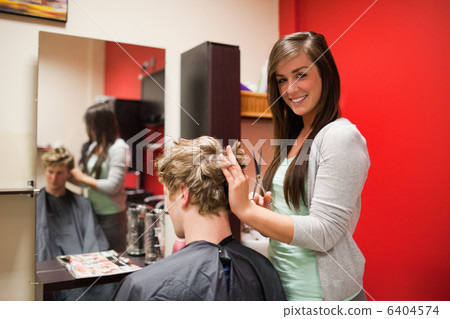 Blond-haired young man having a haircut 6404574