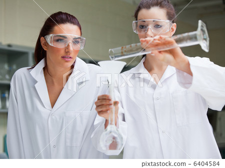 Gorgeous science students doing an experiment Gorgeous science students doing an experiment 6404584