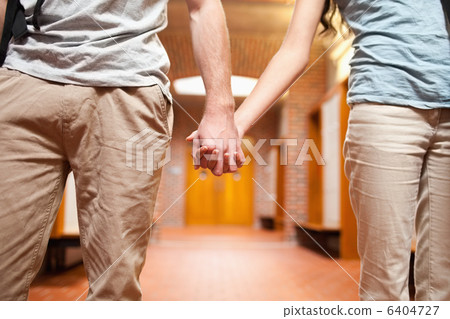 Young couple holding hands 6404727