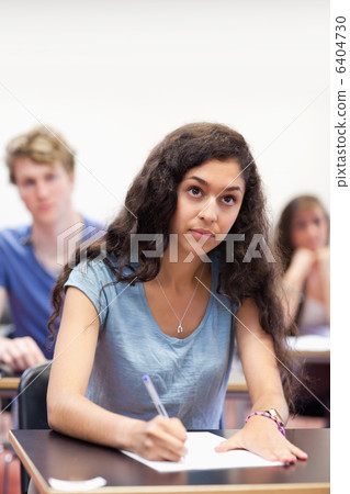 Portrait of a focused student taking notes Portrait of a focused student taking notes 6404730