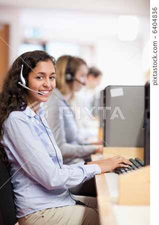 Portrait of a smiling assistant working with a computer 6404836