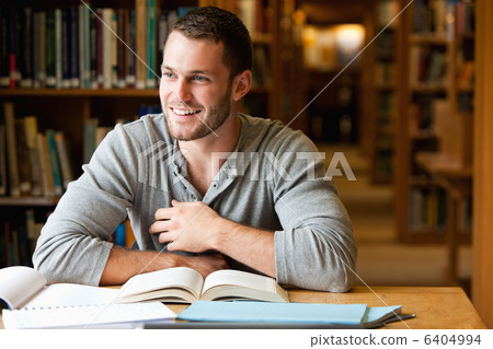 Smiling male student working Smiling male student working 6404994