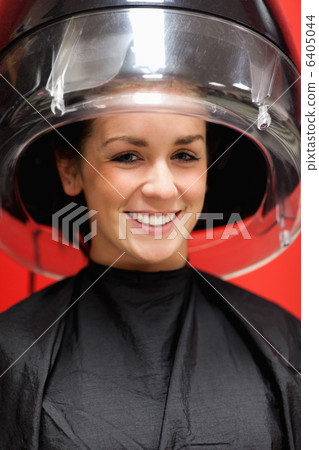 Portrait of a cute student under a hairdressing machine Portrait of a cute student under a hairdressing machine 6405044