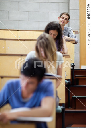 Portrait of young students writing in an amphitheater 6405209