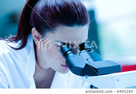 Young scientist using a microscope Young scientist using a microscope 6405284