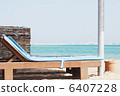 empty beach chair with straw sunshade at the sea 6407228