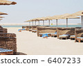 empty beach chair with straw sunshade at the sea 6407233