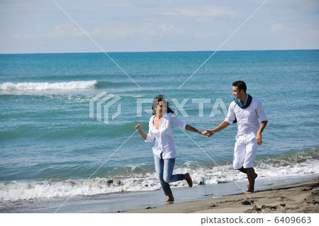 happy young couple have fun at beautiful beach happy young couple have fun at beautiful beach 6409663