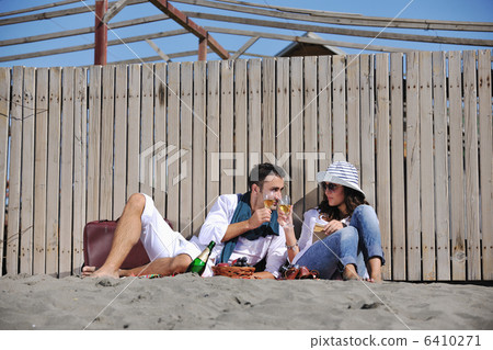 young couple enjoying picnic on the beach 6410271