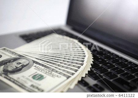 100 dollar banknote and personal computer 6411122