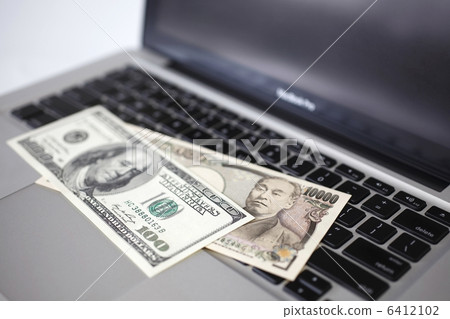 100 dollar bills and 10,000 yen bills and personal computers 6412102