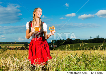 woman with tracht, beer and pretzel in Bavaria woman with tracht, beer and pretzel in Bavaria 6414882