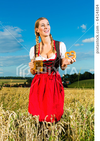 woman with tracht, beer and pretzel in Bavaria 6414884