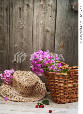 basket of flowers and a straw hat basket of flowers and a straw hat 6417360