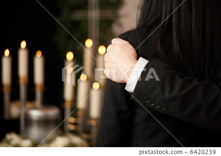 People at funeral consoling each other People at funeral consoling each other 6420239