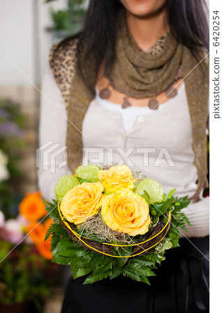 Female florist in flower shop Female florist in flower shop 6420254