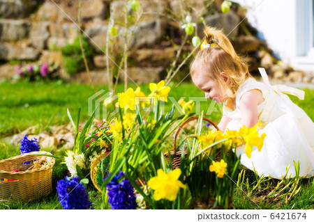 Girl on Easter egg hunt with eggs Girl on Easter egg hunt with eggs 6421674