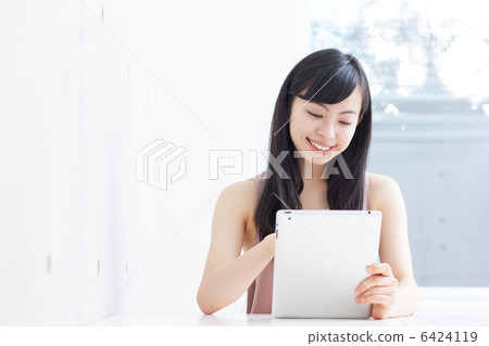A woman using a tablet PC A woman using a tablet PC 6424119