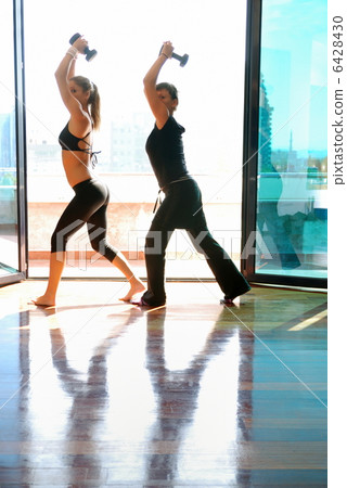 two girls doing exercise with dumbbells 6428430