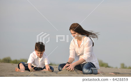 mom and son relaxing on beach mom and son relaxing on beach 6428859