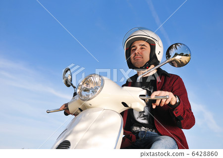 young man on ride scooter young man on ride scooter 6428860