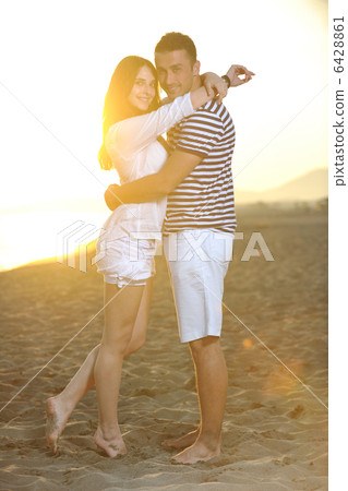 happy young couple have romantic time on beach 6428861