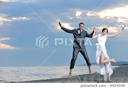 romantic beach wedding at sunset 6429340