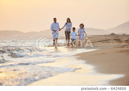 happy young family have fun on beach at sunset happy young family have fun on beach at sunset 6429808