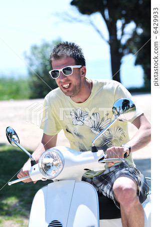 young man ride retro scooter young man ride retro scooter 6429933