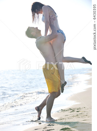 happy young couple have romantic time on beach 6430395