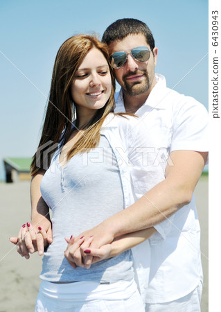 happy young couple have fun on beach 6430943